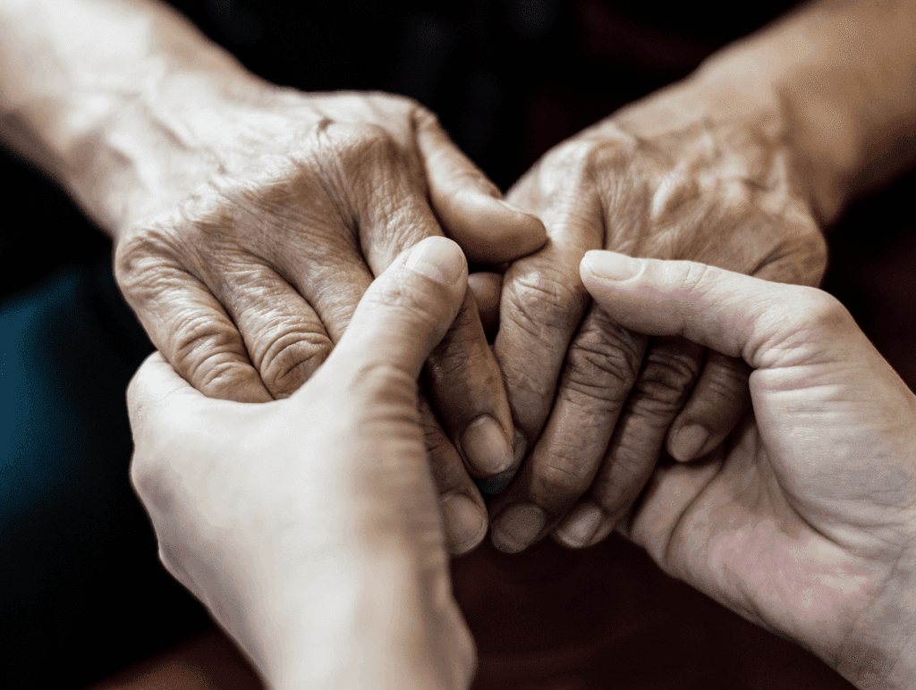 Elderly hands held gently