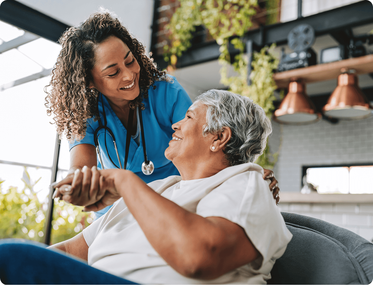 Caregiver supporting senior woman with smile
